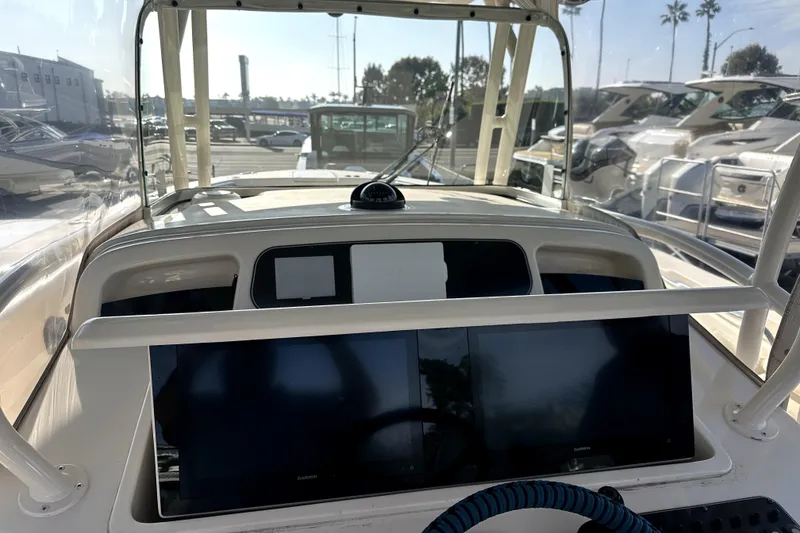 Slide: The Image of 2019 Grady-White Canyon 336 boat dashboard with navigation screens and steering wheel. - 30