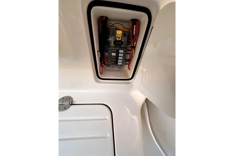 Slide: The Image of Electrical panel inside 2019 Grady-White Canyon 336 boat, featuring wiring and fuse box. - 37