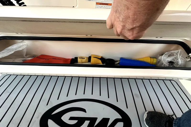 Slide: The Image of Storage compartment on a 2019 Grady-White Canyon 336 boat with emergency marine kit. - 38