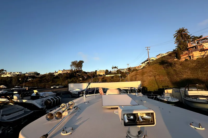 Slide: The Image of 2019 Grady-White Canyon 336 boat docked, scenic coastal view, clear sky. - 39