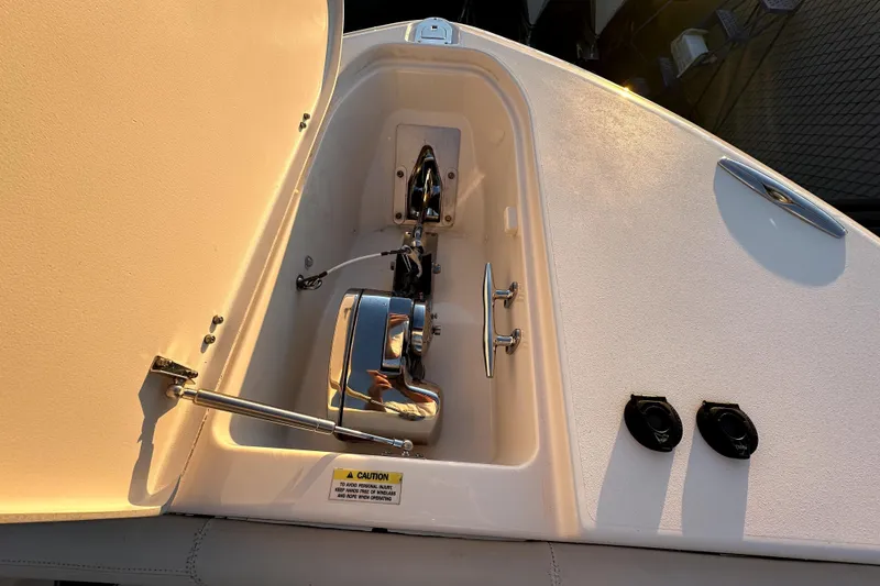Slide: The Image of Anchor compartment of 2019 Grady-White Canyon 336 boat, featuring polished metal components. - 40