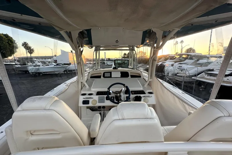Slide: The Image of 2019 Grady-White Canyon 336 boat interior with helm, docked at sunset. - 42