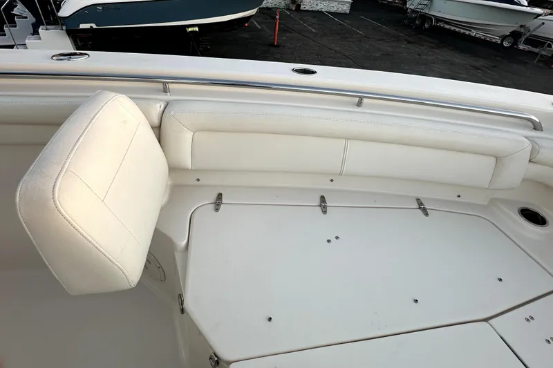 Slide: The Image of 2019 Grady-White Canyon 336 boat interior with white seating and storage compartments. - 46