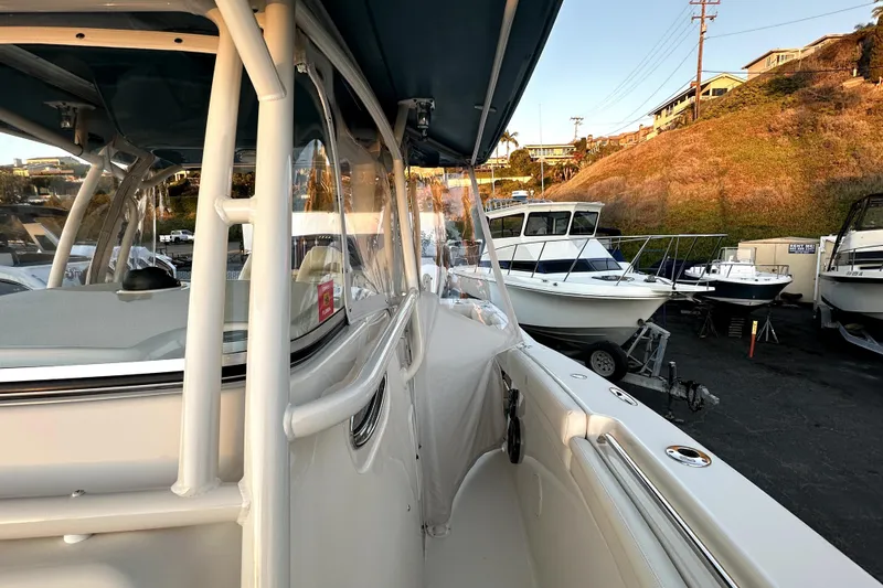 Slide: The Image of 2019 Grady-White Canyon 336 boat docked, side view with other boats nearby. - 49