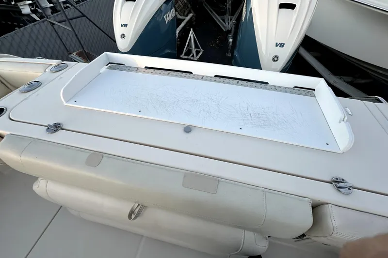 Slide: The Image of 2019 Grady-White Canyon 336 boat with Yamaha V8 engines, featuring a scratched cutting board. - 54