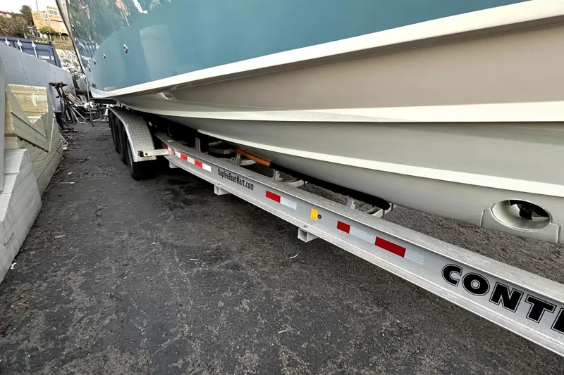 Slide: The Image of 2019 Grady-White Canyon 336 boat on trailer, parked on asphalt. - 56