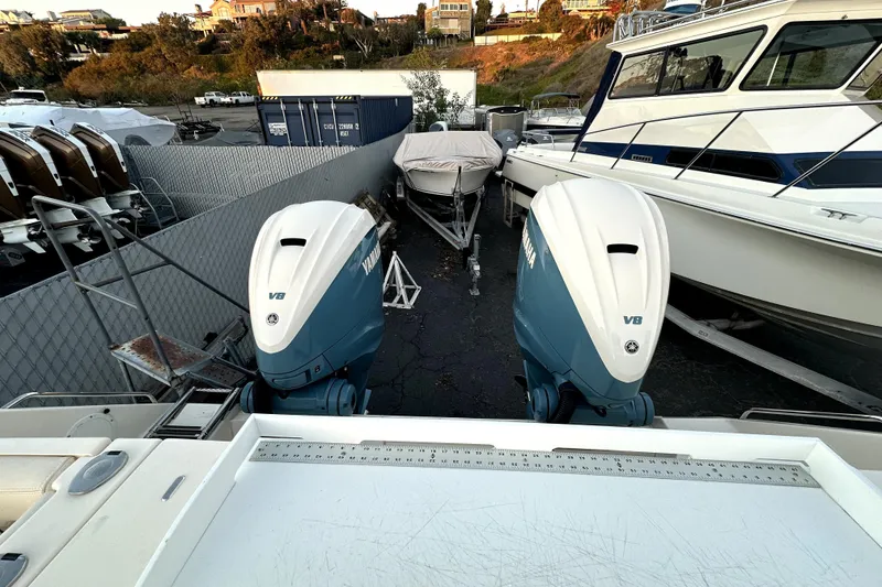 Slide: The Image of 2019 Grady-White Canyon 336 with twin Yamaha V8 engines in a boatyard. - 64