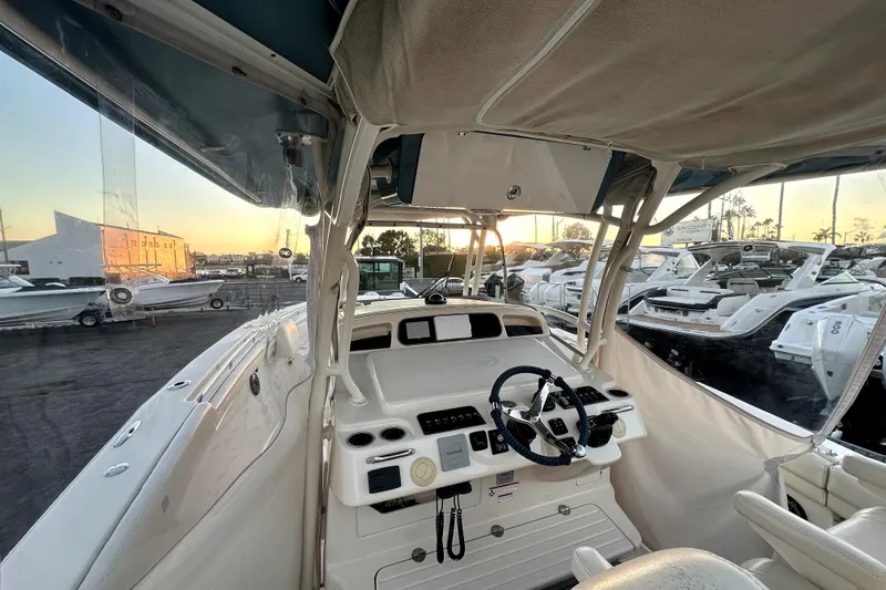 Slide: The Image of 2019 Grady-White Canyon 336 boat interior with steering wheel at sunset. - 66