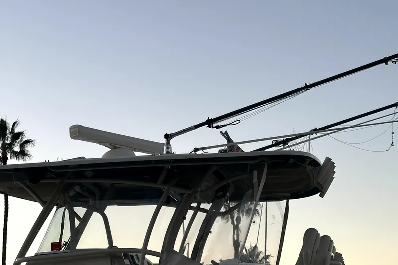 Slide: The Image of 2019 Grady-White Canyon 336 boat with fishing rods against a clear sky. - 72