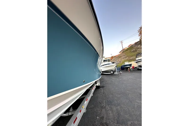 Slide: The Image of 2019 Grady-White Canyon 336 boat on trailer, side view in a marina setting. - 78