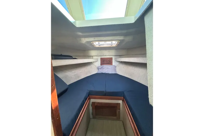 Slide: The Image of Cozy cabin interior of 1998 Blackman Billfisher 26 boat with blue cushions and skylight. - 14