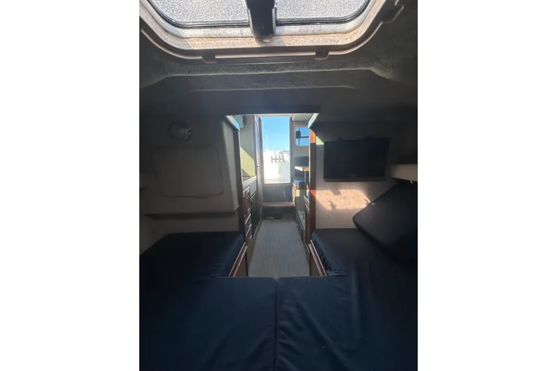 Slide: The Image of Interior cabin of 1998 Blackman Billfisher 26 boat, featuring seating and storage. - 15