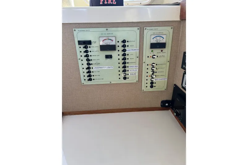 Slide: The Image of Control panel of a 1998 Blackman Billfisher 26 boat, featuring various switches and gauges. - 18