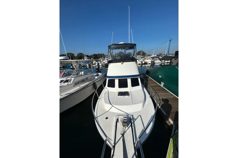 Slide: The Image of 1998 Blackman Billfisher 26 boat docked at marina under clear blue sky. - 3