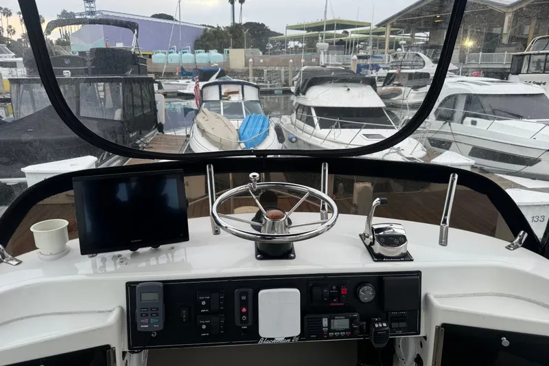 Slide: The Image of Cockpit view of a 1998 Blackman Billfisher 26 boat docked at a marina. - 7
