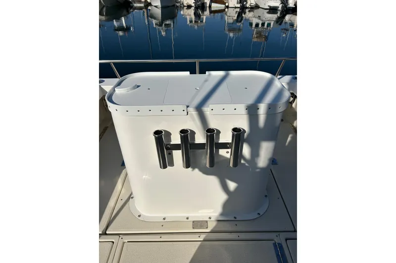 Slide: The Image of 1998 Blackman Billfisher 26 boat with rod holders, docked at marina. - 9