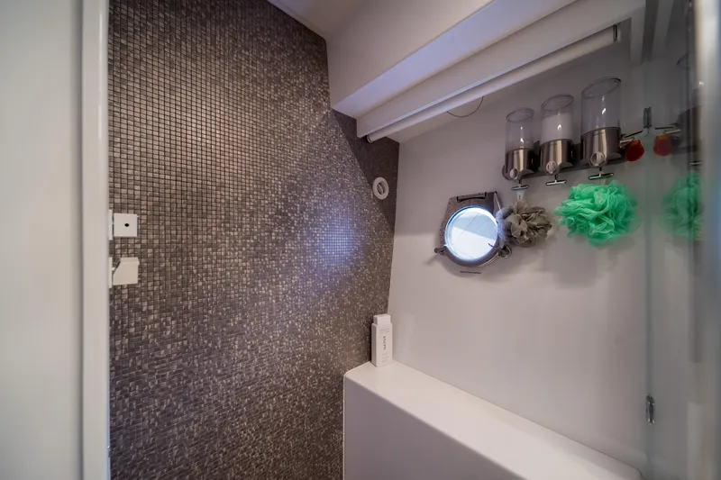 Slide: The Image of Luxurious bathroom in 2018 Ferretti Yachts 450 fly with mosaic tiles and porthole window. - 22