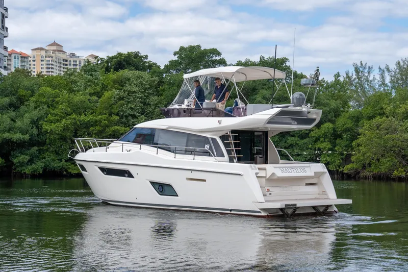 Slide: The Image of 2018 Ferretti Yachts 450 Fly cruising on a scenic waterway with lush greenery. - 29