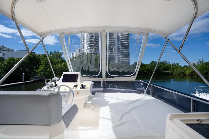 Slide: The Image of Flybridge view of 2018 Ferretti Yachts 450, featuring modern helm and scenic backdrop. - 4