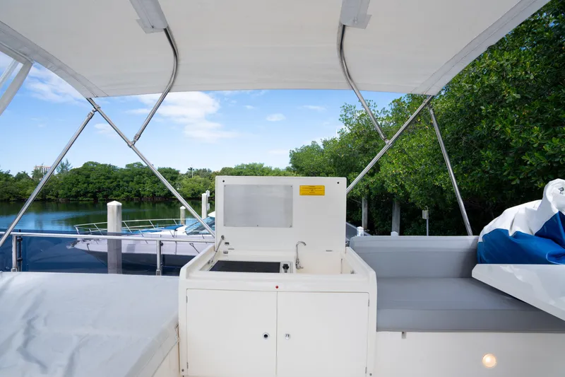 Slide: The Image of Flybridge view of 2018 Ferretti Yachts 450 Fly, featuring outdoor seating and sink. - 9