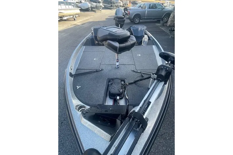 Slide: The Image of 2020 Ranger 107 Cherokee fishing boat with seating and equipment, parked outdoors. - 4