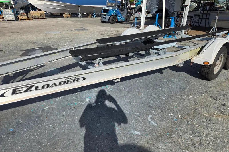 Slide: The Image of 2013 EZ Loader 21-25 trailer with boats on stands in a marina setting. - 5