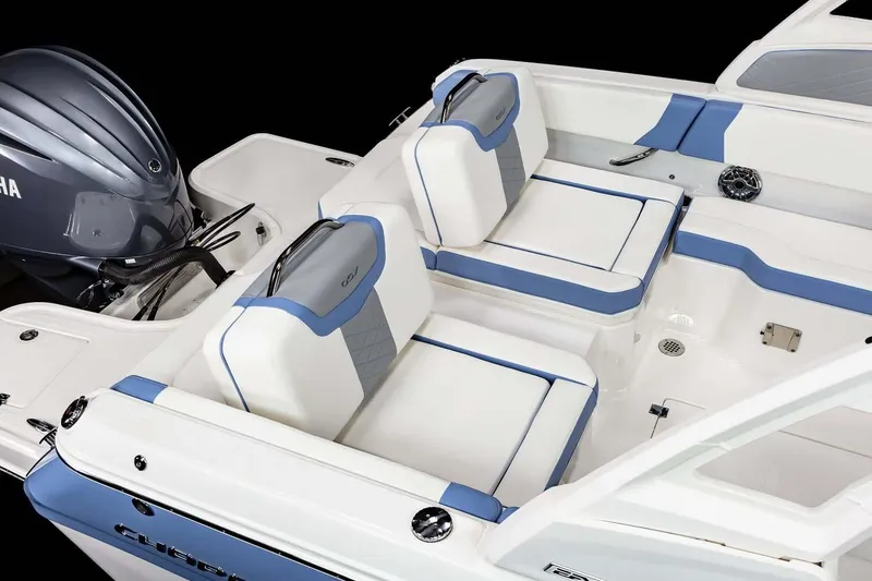 Slide: The Image of 2026 Chaparral 250 OSX boat interior with modern seating and sleek design in showroom. - 10
