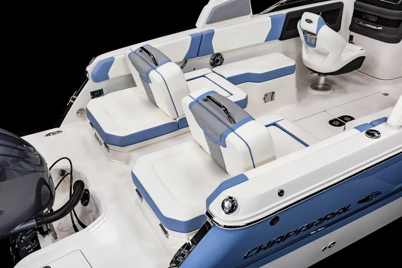 Slide: The Image of Interior of 2026 Chaparral 250 OSX boat with modern seating and blue ambient lighting. - 11