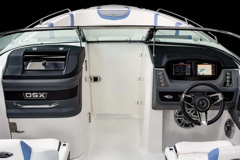 Slide: The Image of 2026 Chaparral 250 OSX boat interior with modern seating and sleek design at a showroom. - 4