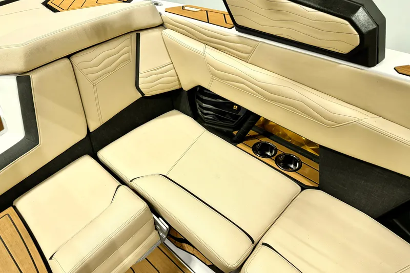 Slide: The Image of Luxurious interior of 2025 Nautique Super Air Nautique G21 boat with beige seating. - 12