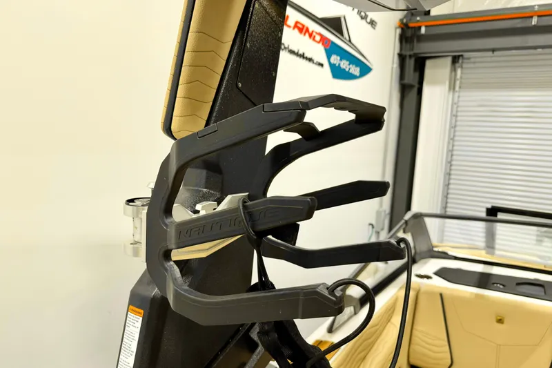 Slide: The Image of 2025 Nautique Super Air Nautique G21 wakeboard rack in a showroom setting. - 17