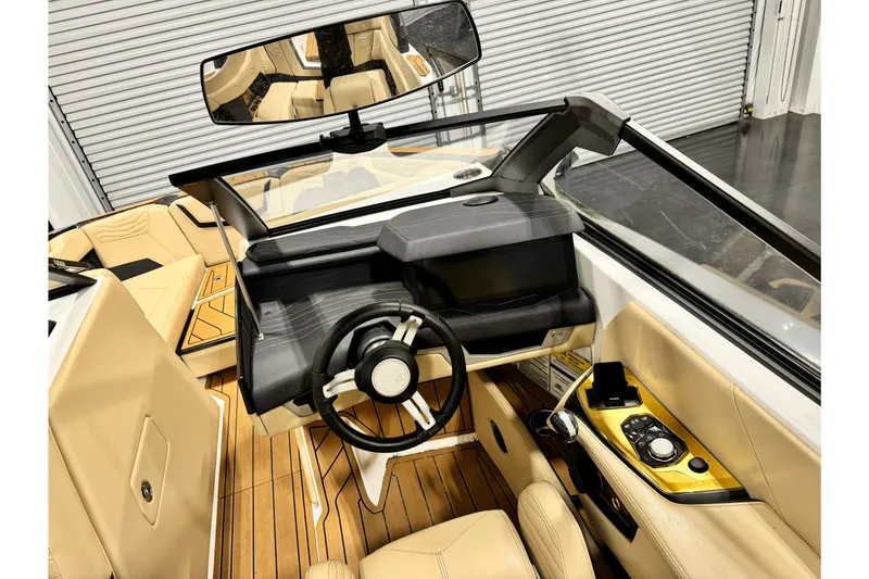 Slide: The Image of 2025 Nautique Super Air Nautique G21 interior with sleek dashboard and luxurious seating. - 7