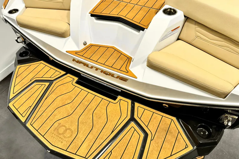 Slide: The Image of 2025 Nautique Super Air Nautique G21 boat interior with tan seating and custom flooring. - 8