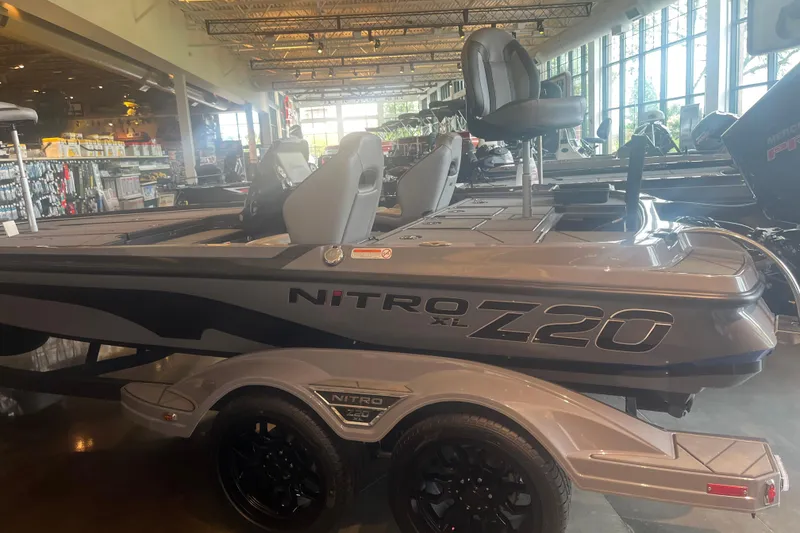 Slide: The Image of 2026 Nitro Z20 XL Pro boat displayed in a showroom, featuring sleek design and modern seating. - 1