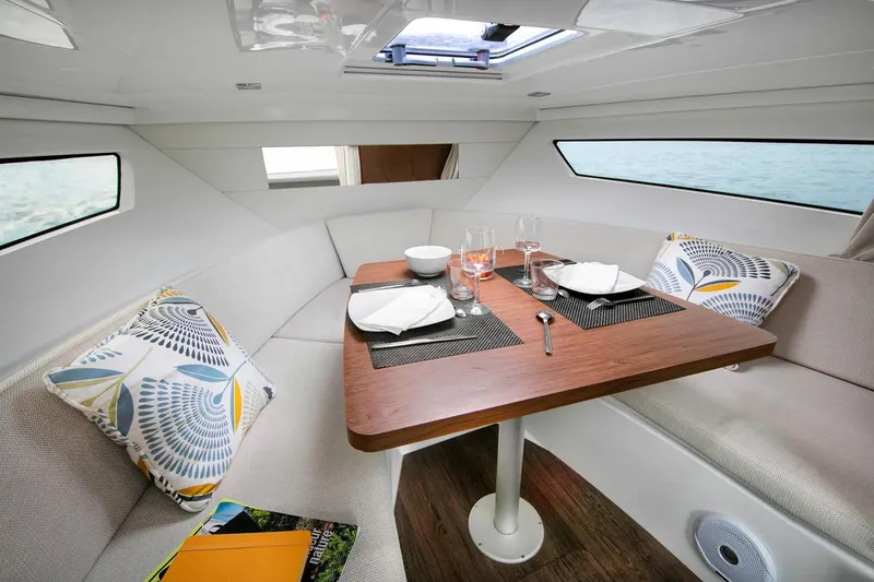 Slide: The Image of 2024 Jeanneau Leader 9.0 WA boat interior with gray seating and dual engines. - 11