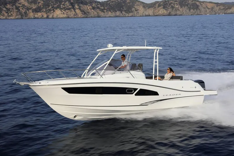 Slide: The Image of 2024 Jeanneau Leader 9.0 WA cabin interior with plastic-covered bedding and wooden accents. - 4