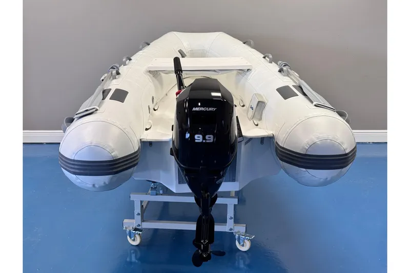 Slide: The Image of 2024 Caribe L-9 inflatable boat with Mercury 9.9 outboard motor on display. - 4