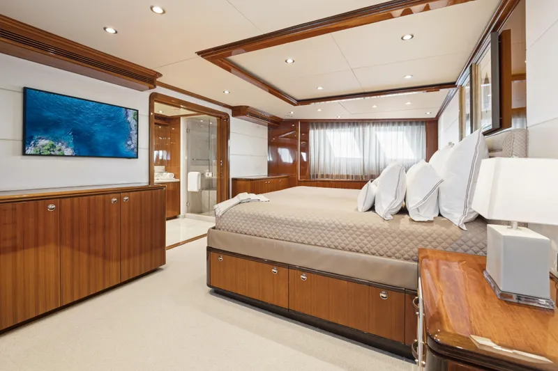Slide: The Image of Luxurious 1990 Delta Expedition yacht bedroom with elegant wood finishes and modern amenities. - 18