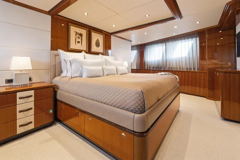 Slide: The Image of Luxurious bedroom interior on 1990 Delta Expedition yacht, featuring elegant wood paneling and modern decor. - 19