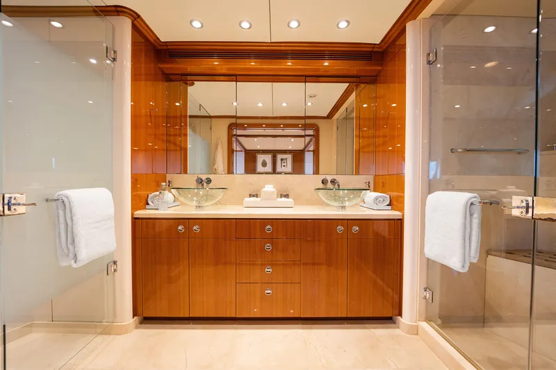 Slide: The Image of Luxurious yacht bathroom with glass sinks, wooden cabinetry, and elegant lighting, Delta Expedition 1990. - 21