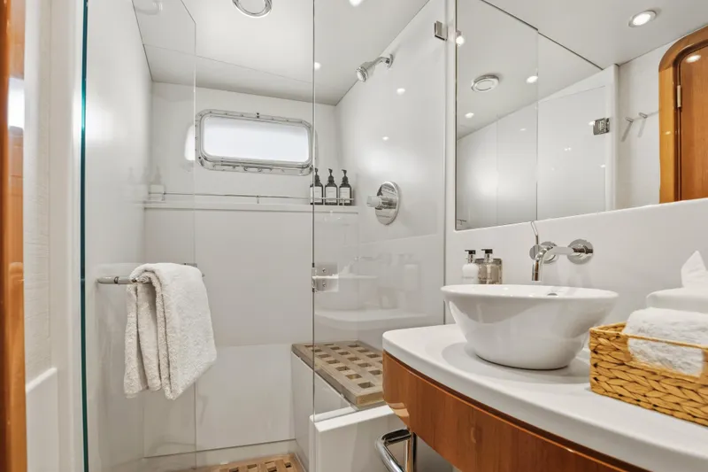 Slide: The Image of Luxurious yacht bathroom with modern fixtures, glass shower, and elegant sink on Delta Expedition 1990. - 26