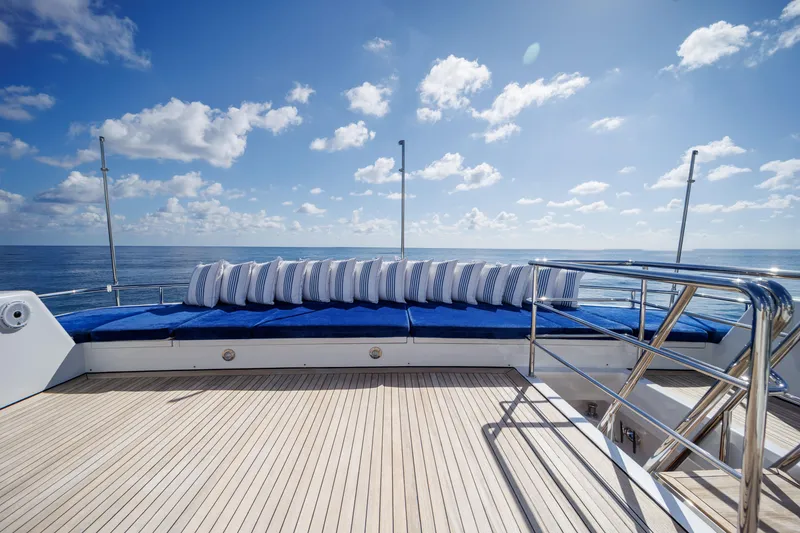 Slide: The Image of Luxurious deck of 1990 Delta Expedition yacht with blue cushions and ocean view. - 38