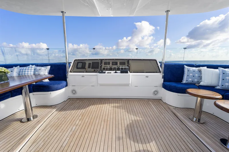 Slide: The Image of Luxurious 1990 Delta Expedition yacht deck with blue seating and ocean view. - 43