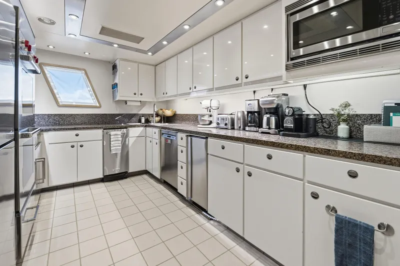 Slide: The Image of Modern kitchen in 1990 Delta Expedition yacht with white cabinets and stainless steel appliances. - 44