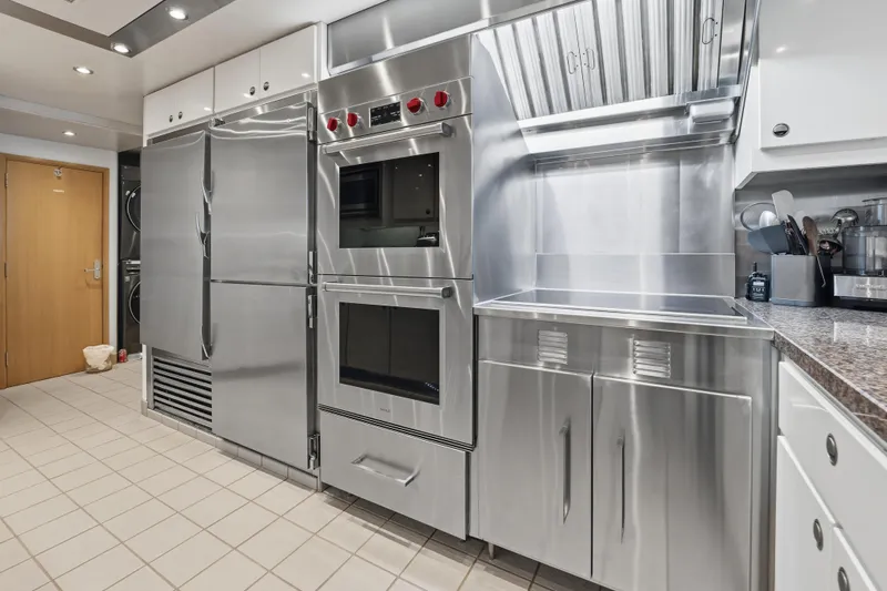 Slide: The Image of Modern stainless steel kitchen appliances in a sleek, professional setting, Delta Expedition 1990 model. - 45