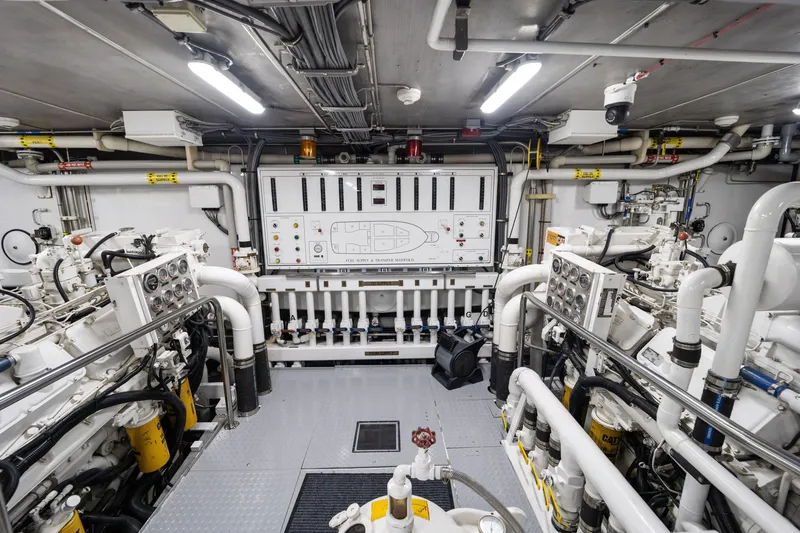 Slide: The Image of Engine room of 1990 Delta Expedition yacht with complex machinery and control panels. - 49