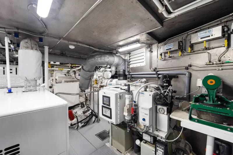 Slide: The Image of Engine room of a 1990 Delta Expedition vessel, featuring complex machinery and piping systems. - 50