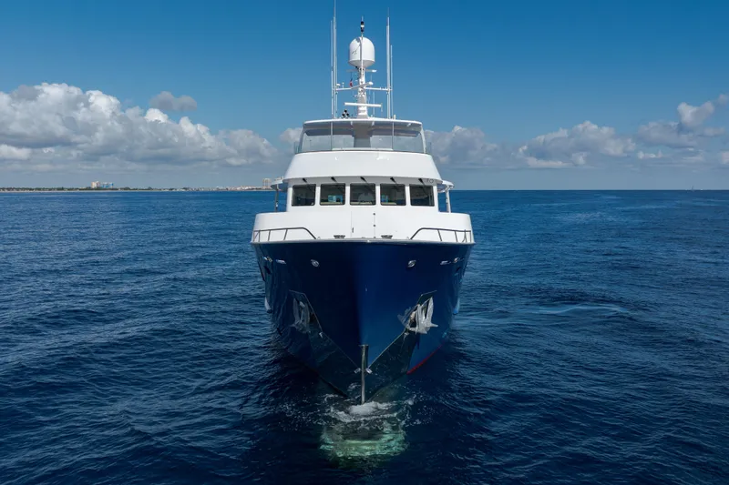 Slide: The Image of Front view of 1990 Delta Expedition yacht cruising on open sea under blue sky. - 55