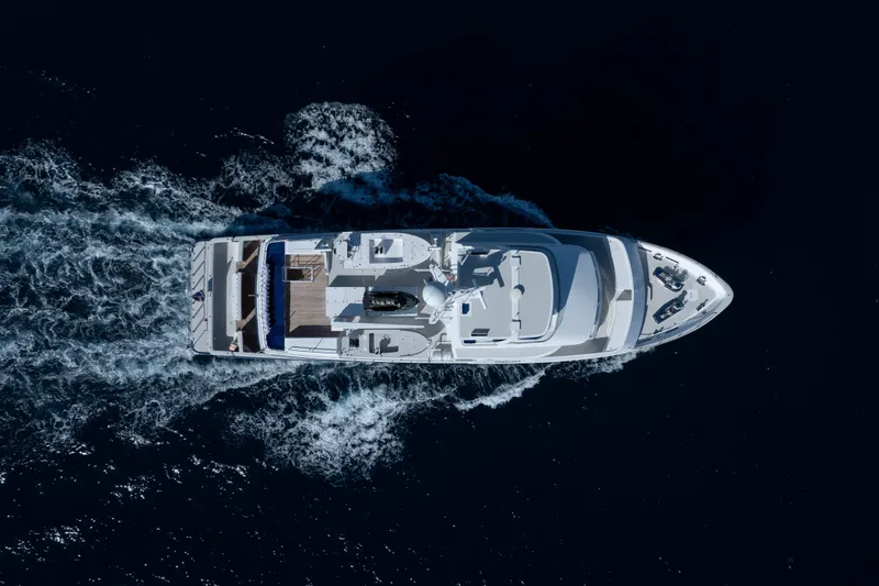 Slide: The Image of Aerial view of 1990 Delta Expedition yacht cruising through dark blue ocean waters. - 58