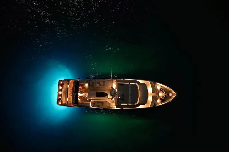 Slide: The Image of Aerial view of illuminated 1990 Delta Expedition yacht on dark water. - 59